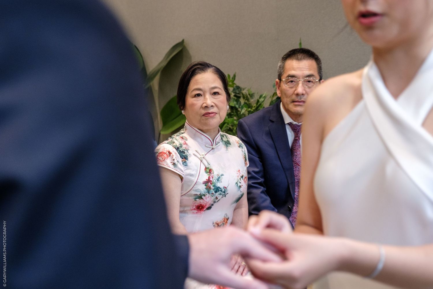 A collage of intimate moments captured during a wedding celebration showing jewelry, dress details and floral decor.