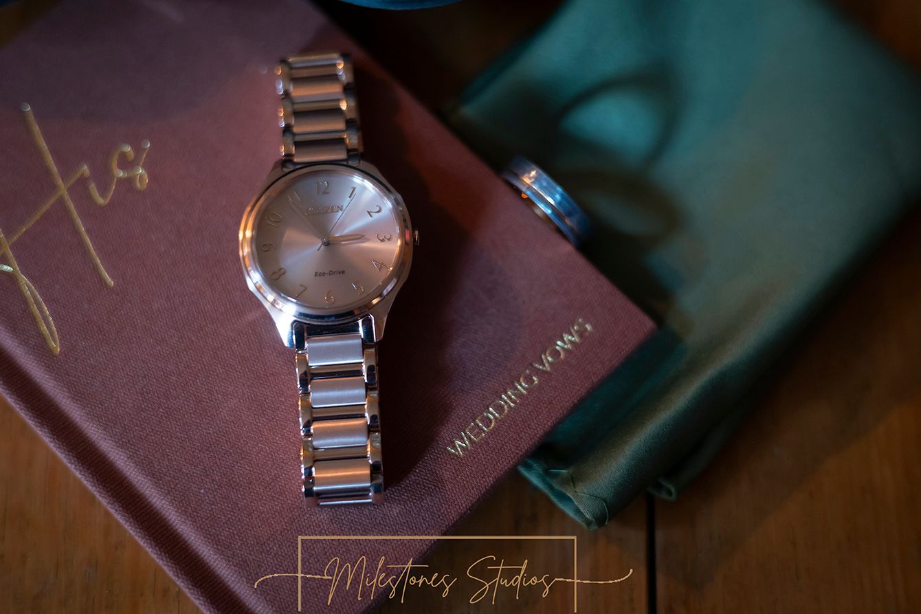 groom's watch ring and vow books