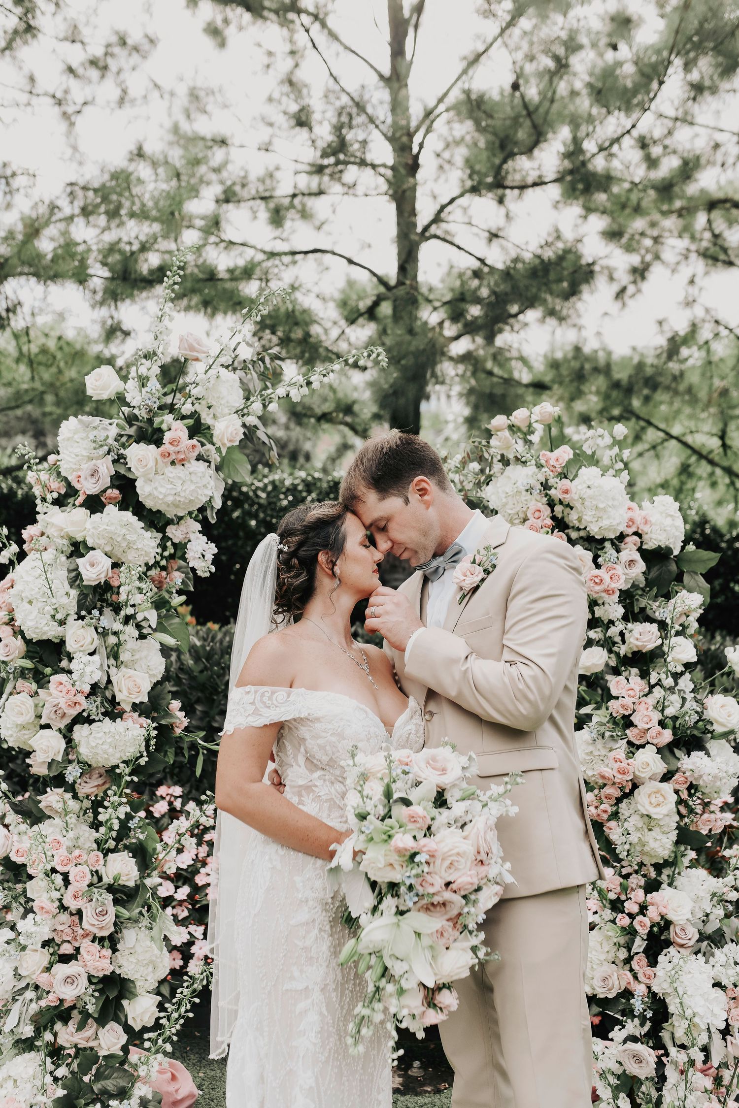 romantic moment between the groom and bride as he leans in to kiss her