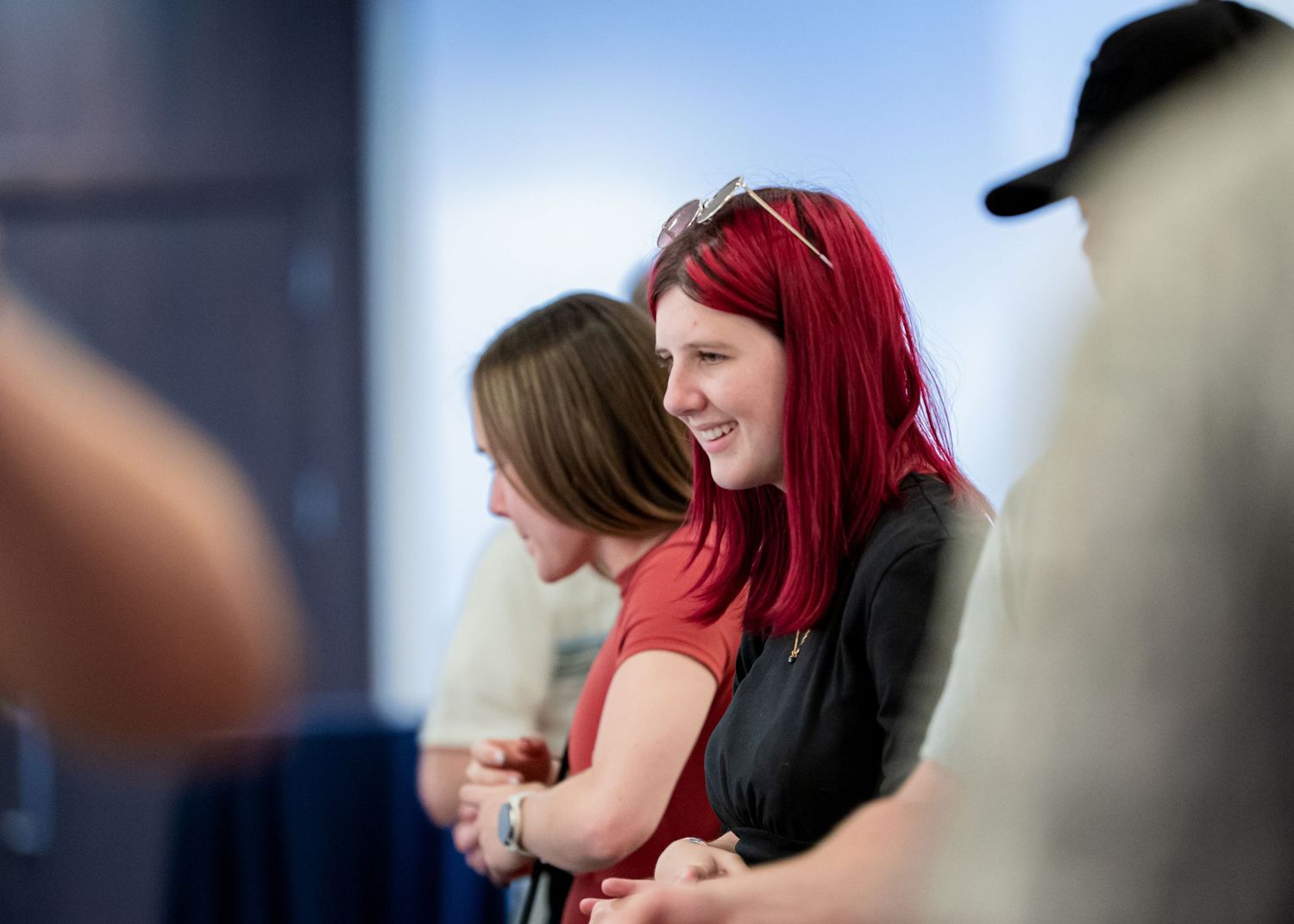 Two attendees share a close moment at a social gathering.
