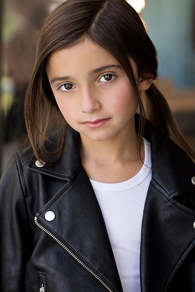 Close-up portrait series showing a figure in a black leather jacket and white top against a soft blurred background in multiple angles.