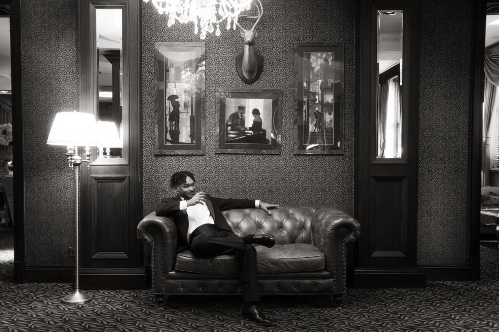 Haunting black and white movie theater lobby with vintage furniture and dramatic lighting creates an eerie atmosphere.