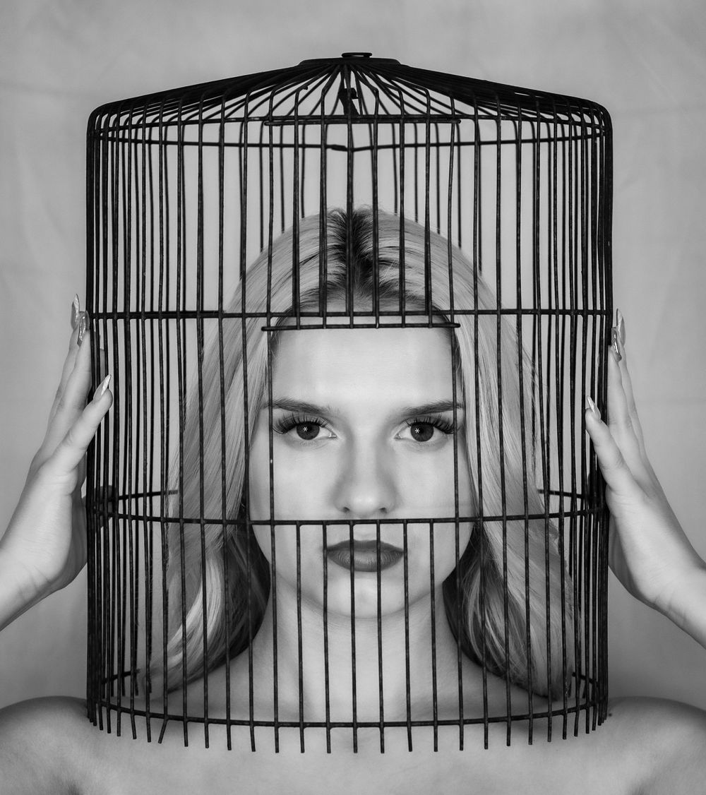 Chattanooga area artistic photo of woman's head in a bird cage.