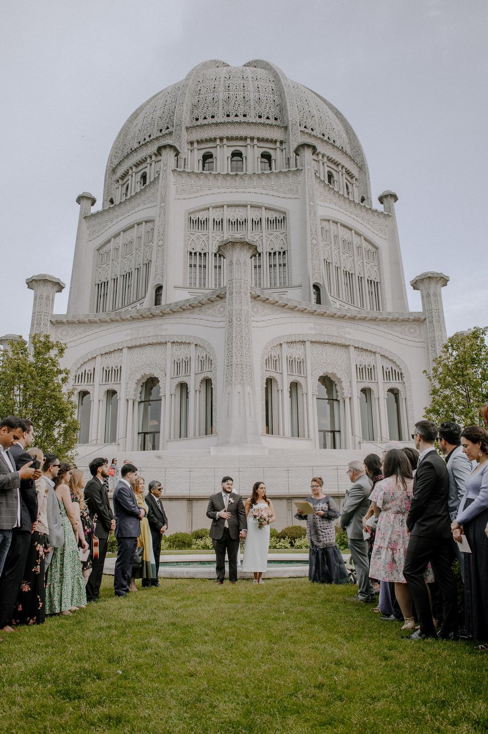 A wedding ceremony takes place on the lawn in front of the majestic Baha'i House of Worship in Wilmette, Illinois.