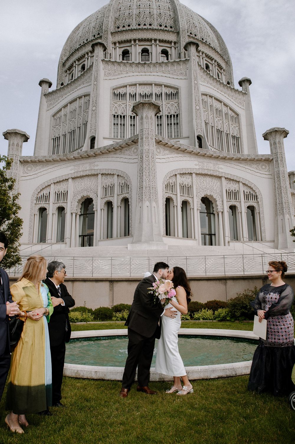A wedding ceremony taking place in front of the iconic Baha'i Temple with its ornate white domed architecture in Wilmette.