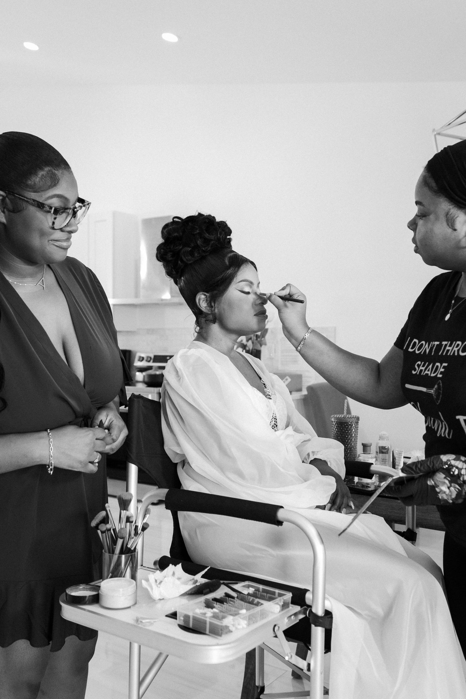 Professional makeup artist at work during a wedding preparation session.