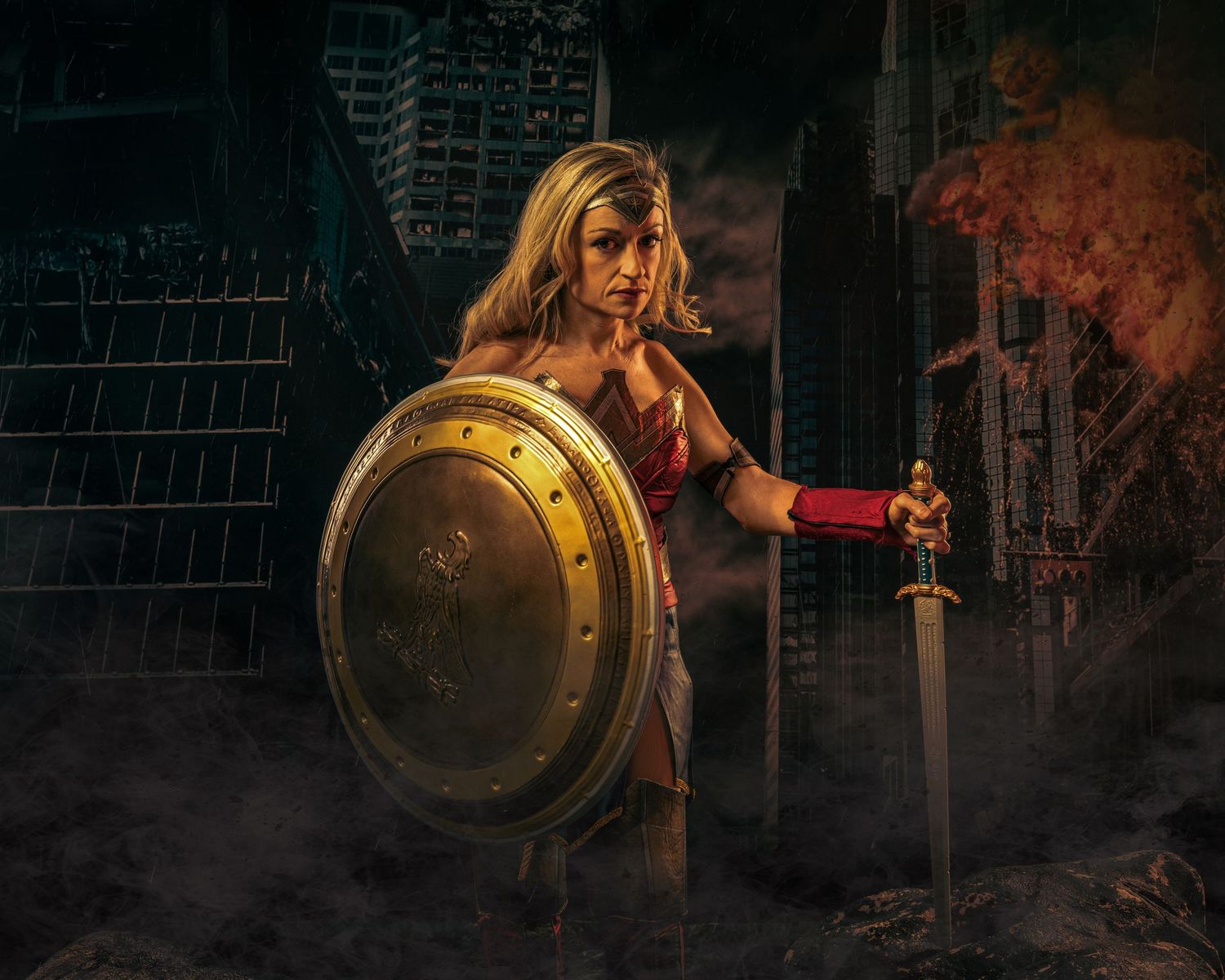 A warrior poses with shield and sword in a smoky battlefield setting.