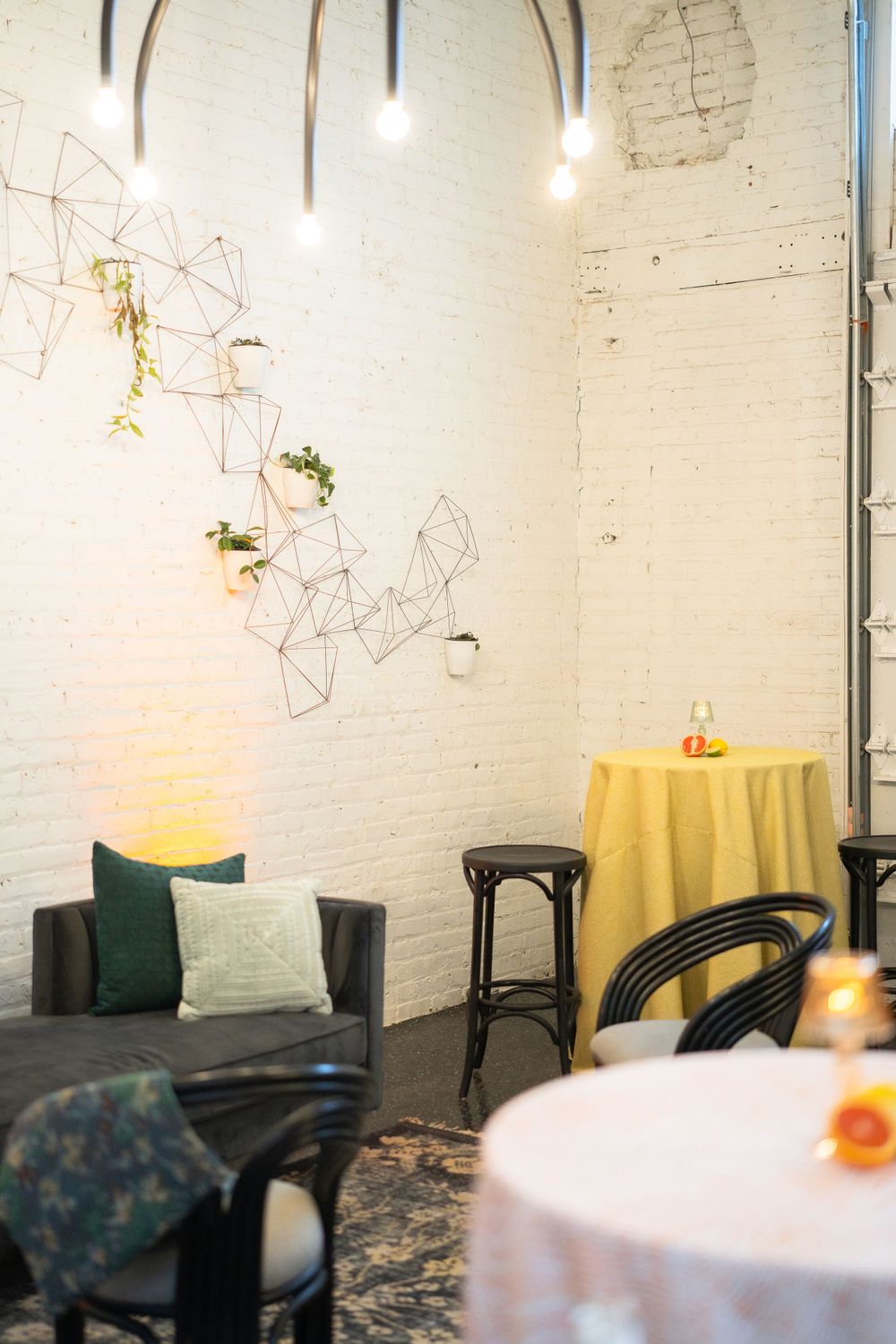Contemporary lounge space with geometric wall art and yellow accent table.