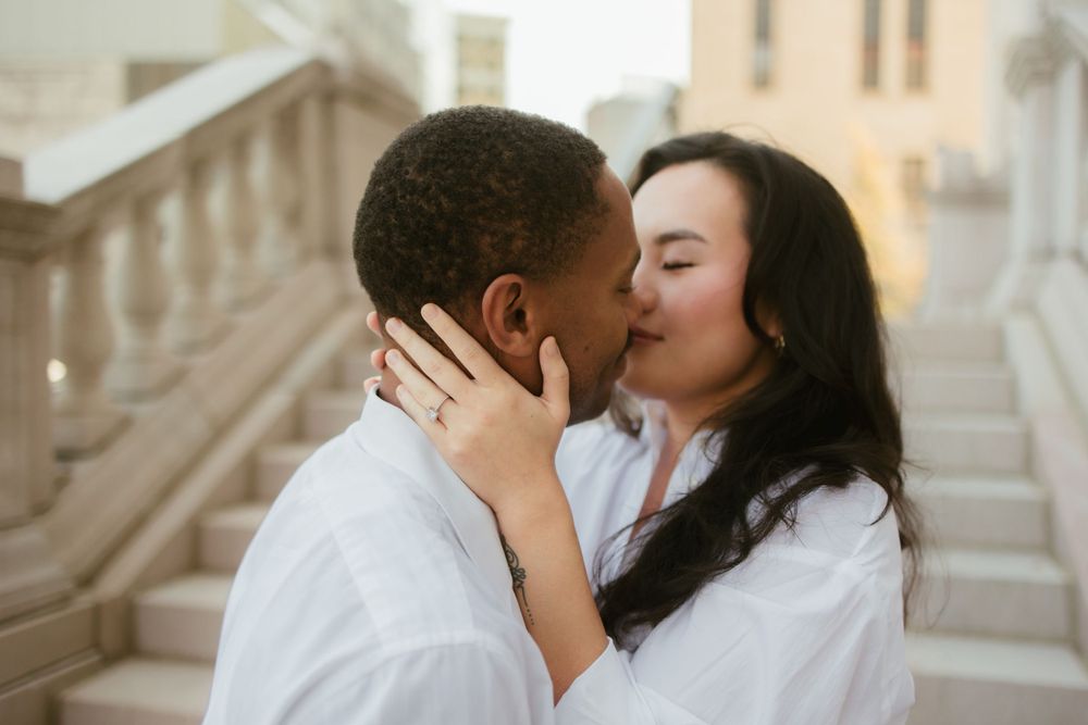 A romantic moment shared between two people on marble steps.