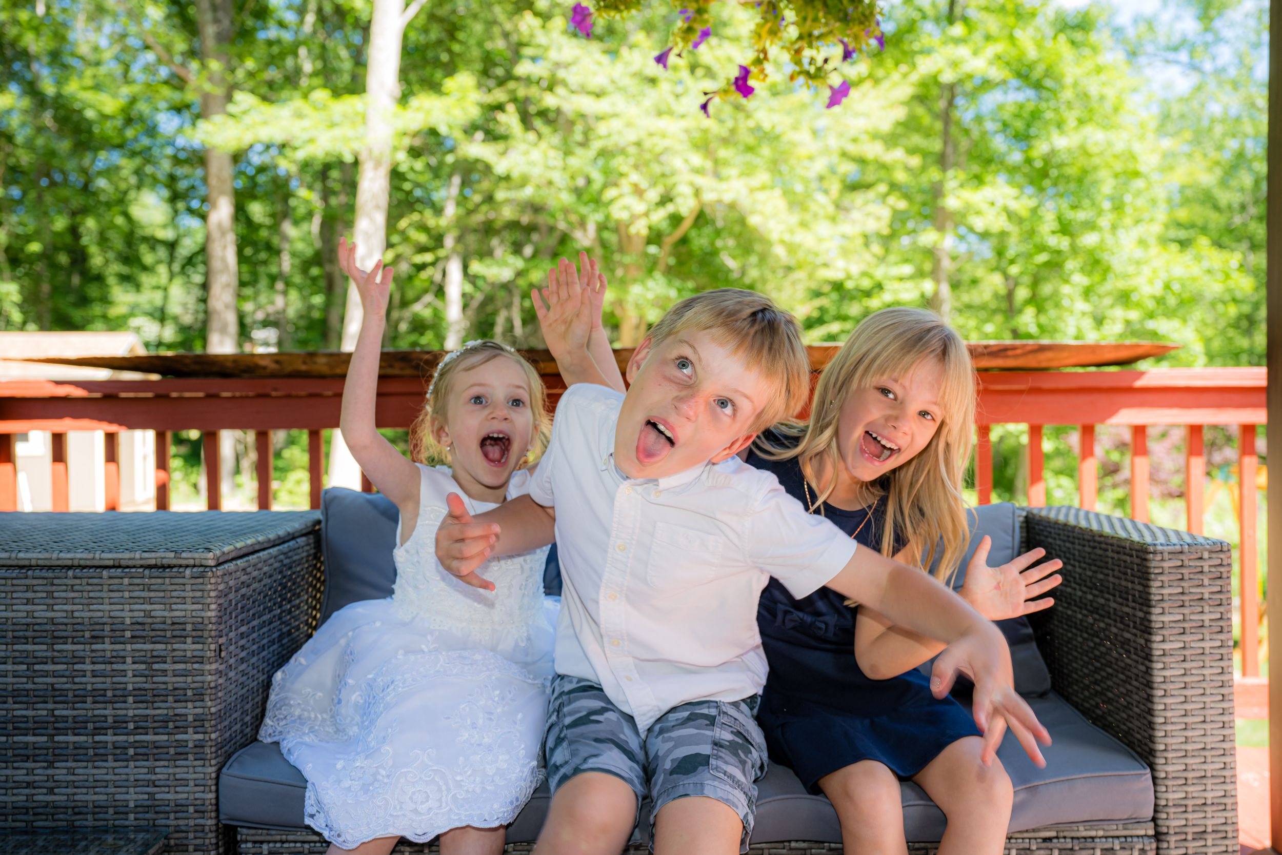 Three kids with funny faces .