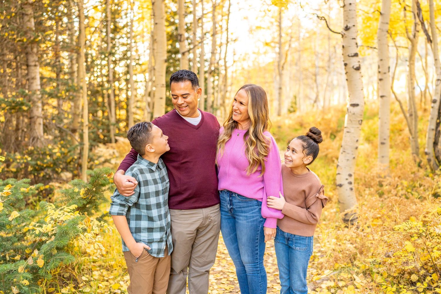 True to color photo of family in fall leaves in Alta canyon.