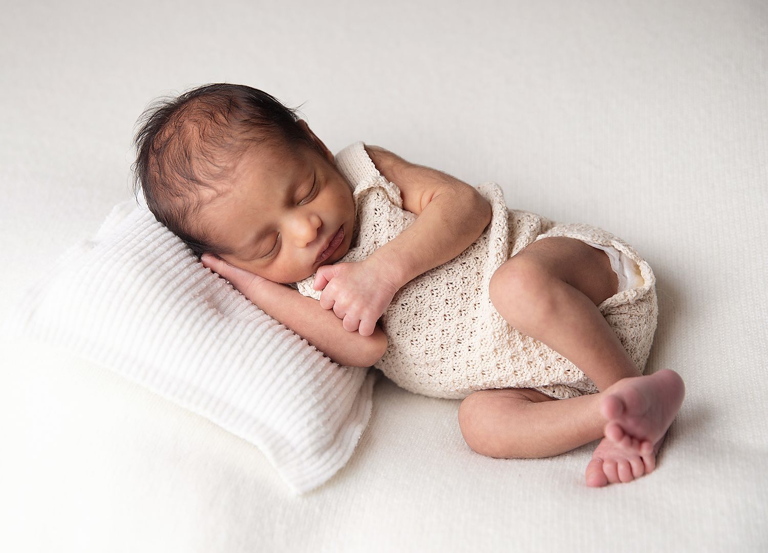 Newborn in soft neutral outfit for natural photoshoot in London