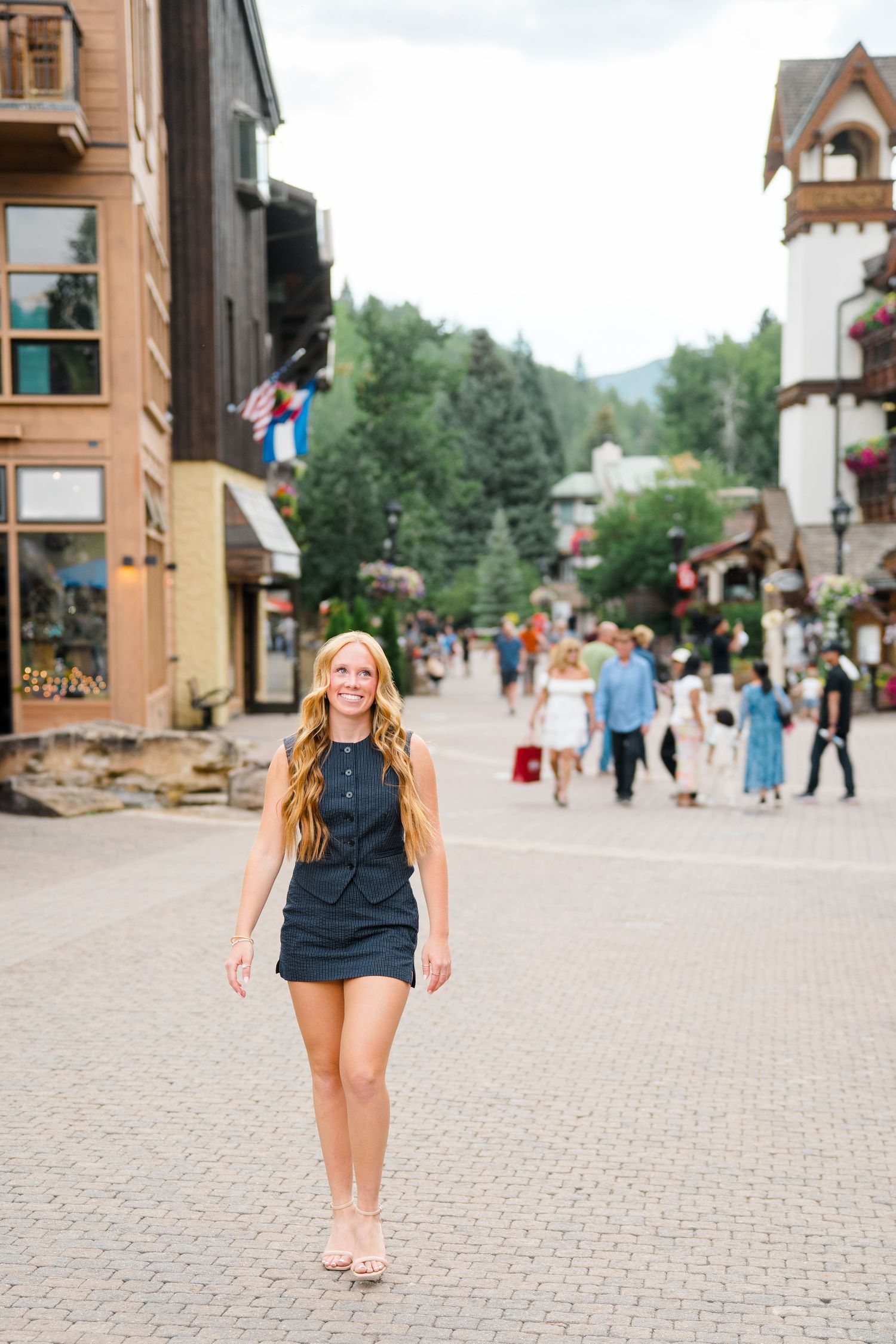 girl walking through vail smiling