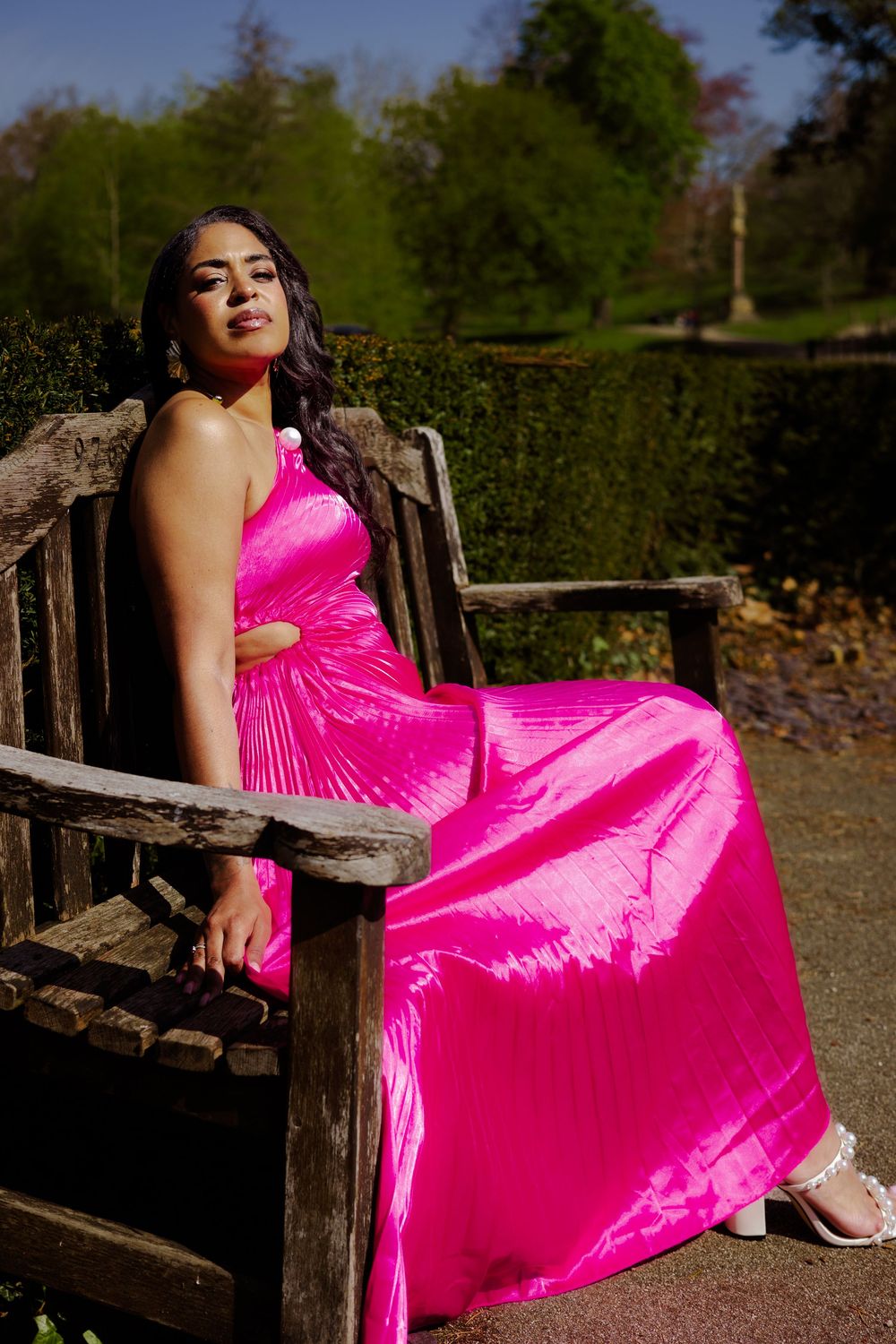 personal branding photoshoot at the Christchurch mansion in Ipswich, sitting on a bench, wearing a bright pink gown, powerful, feminine