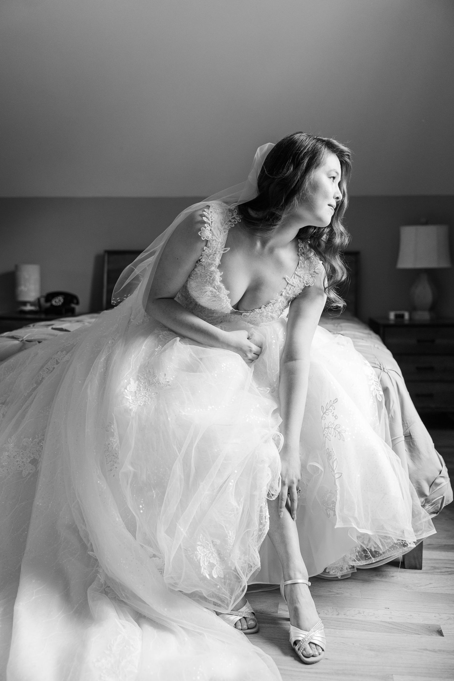 Black and white artistic wedding dress photos showing details of flowing tulle layers and elegant movement.