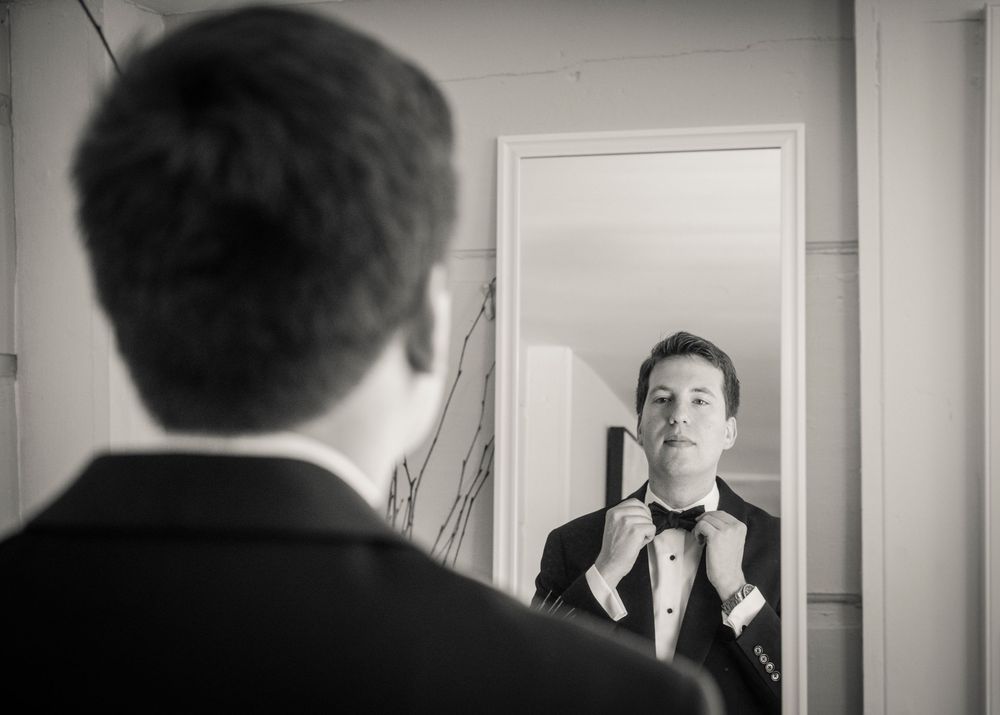 A series of black and white self portraits in a grid layout showing various expressive poses and emotions.