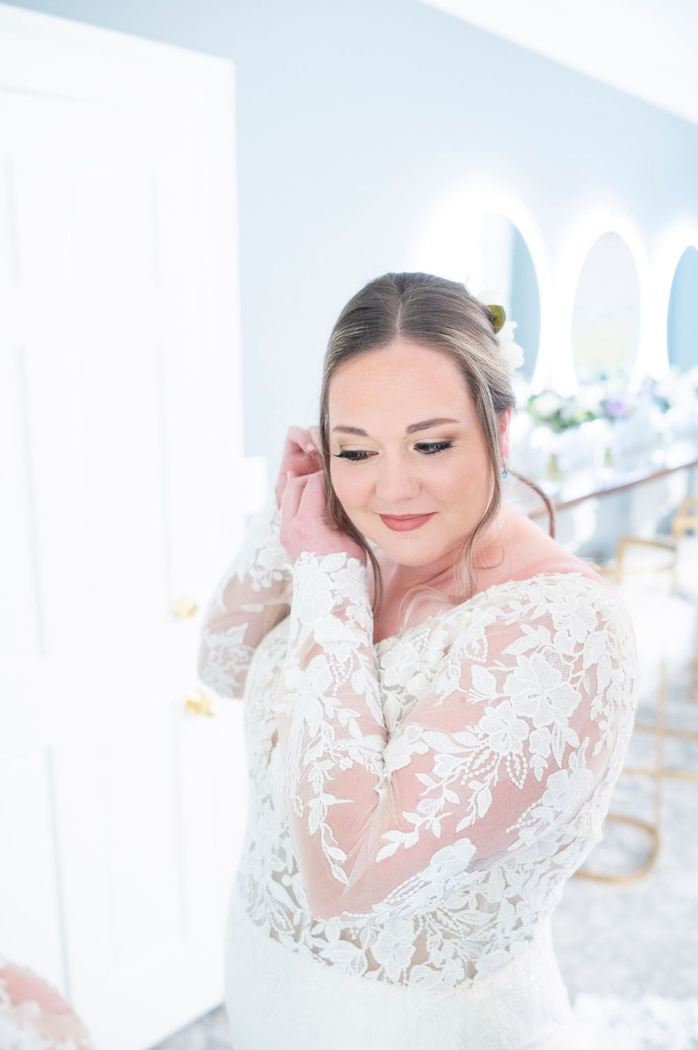 Close up portraits of bride in delicate white lace wedding dress with floral details and subtle romantic makeup. Primrose Cottage Wedding