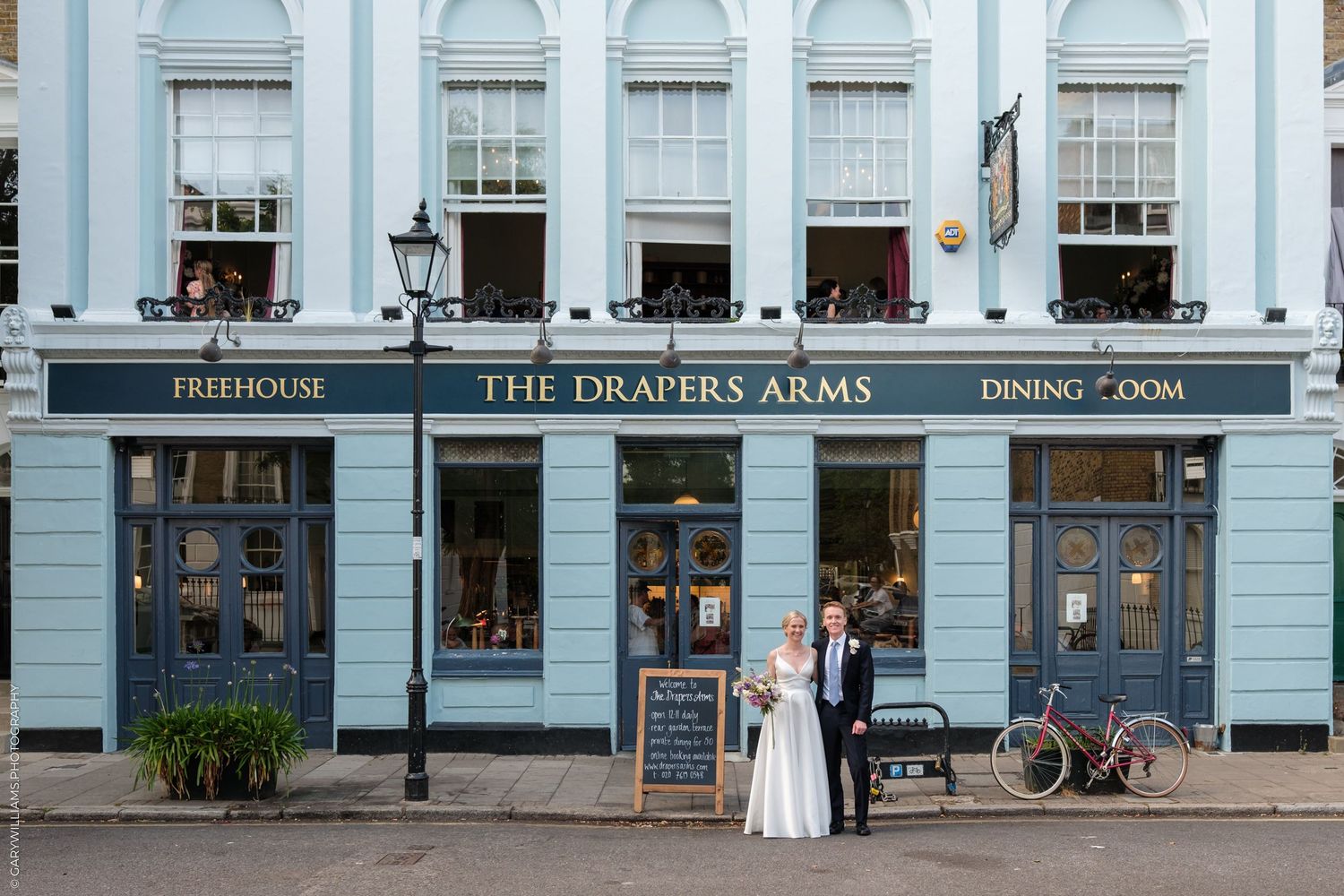 Historic blue-painted pub exterior of The Draper's Arms in London with traditional white framed windows.