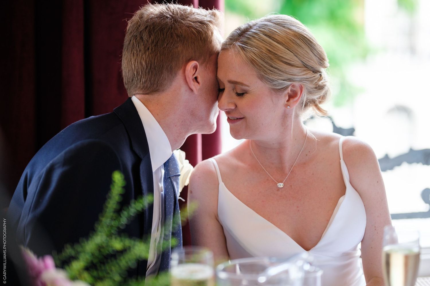 Two wedding couple sharing romantic kisses in seven connected photos showing their affection and celebration.