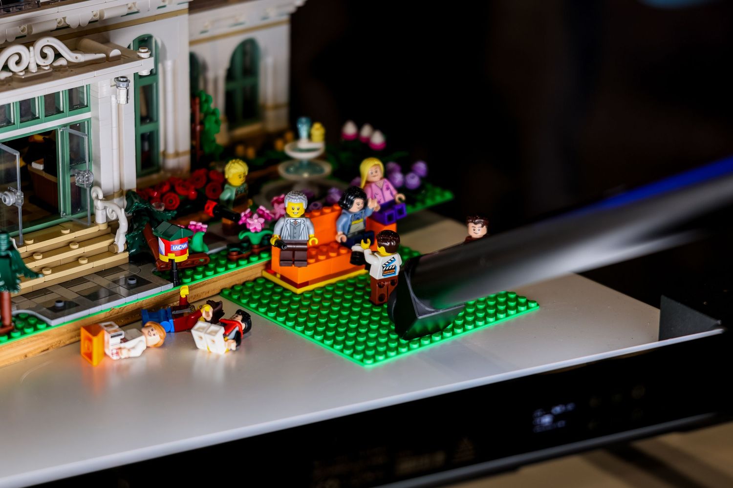 LEGO builds and minifigures displayed on a dark surface with dramatic lighting creating a moody atmosphere.