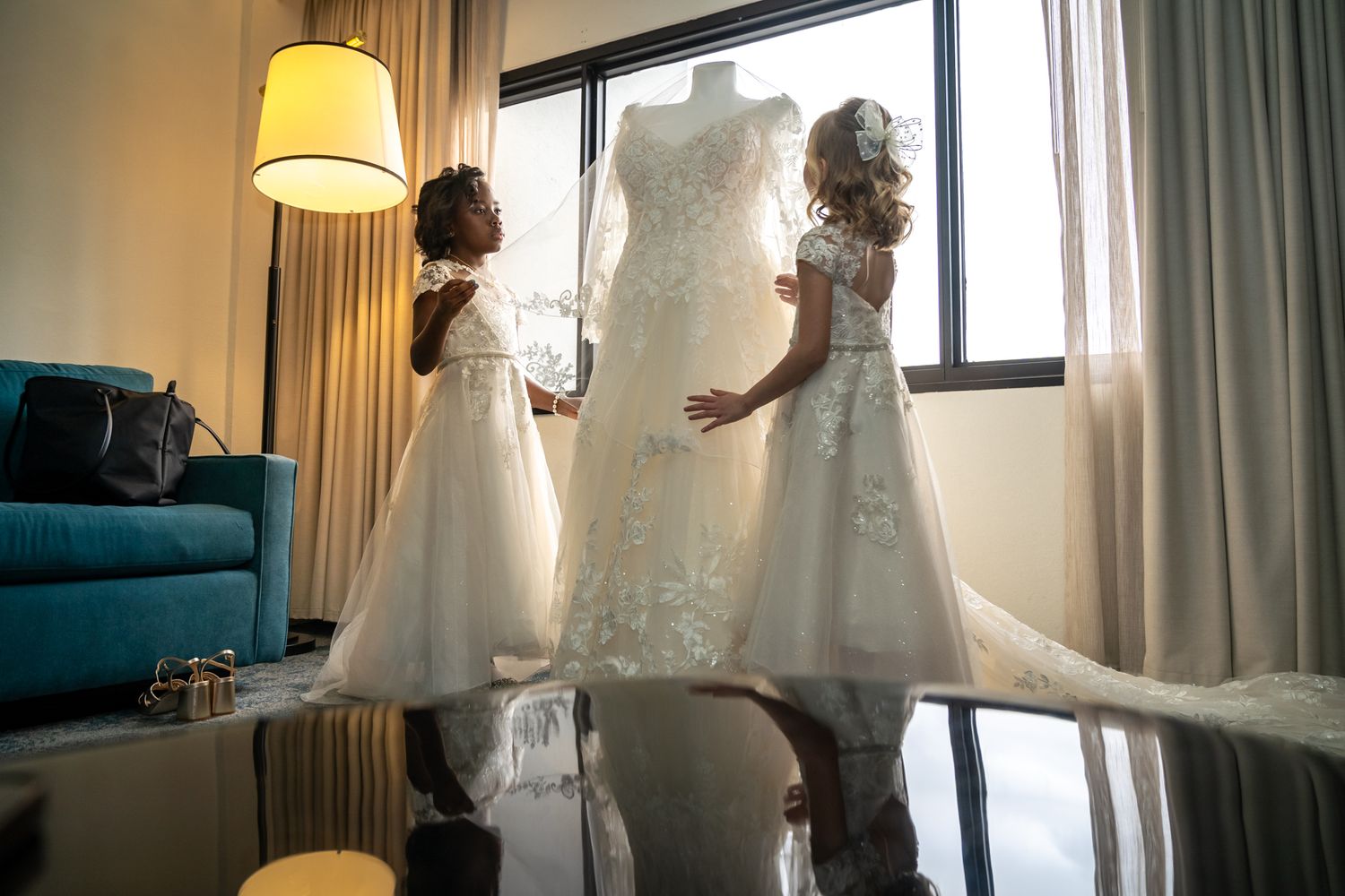 Bride gazing out over Tampa Bay from a historic venue balcony, professionally photographed in golden natural light.