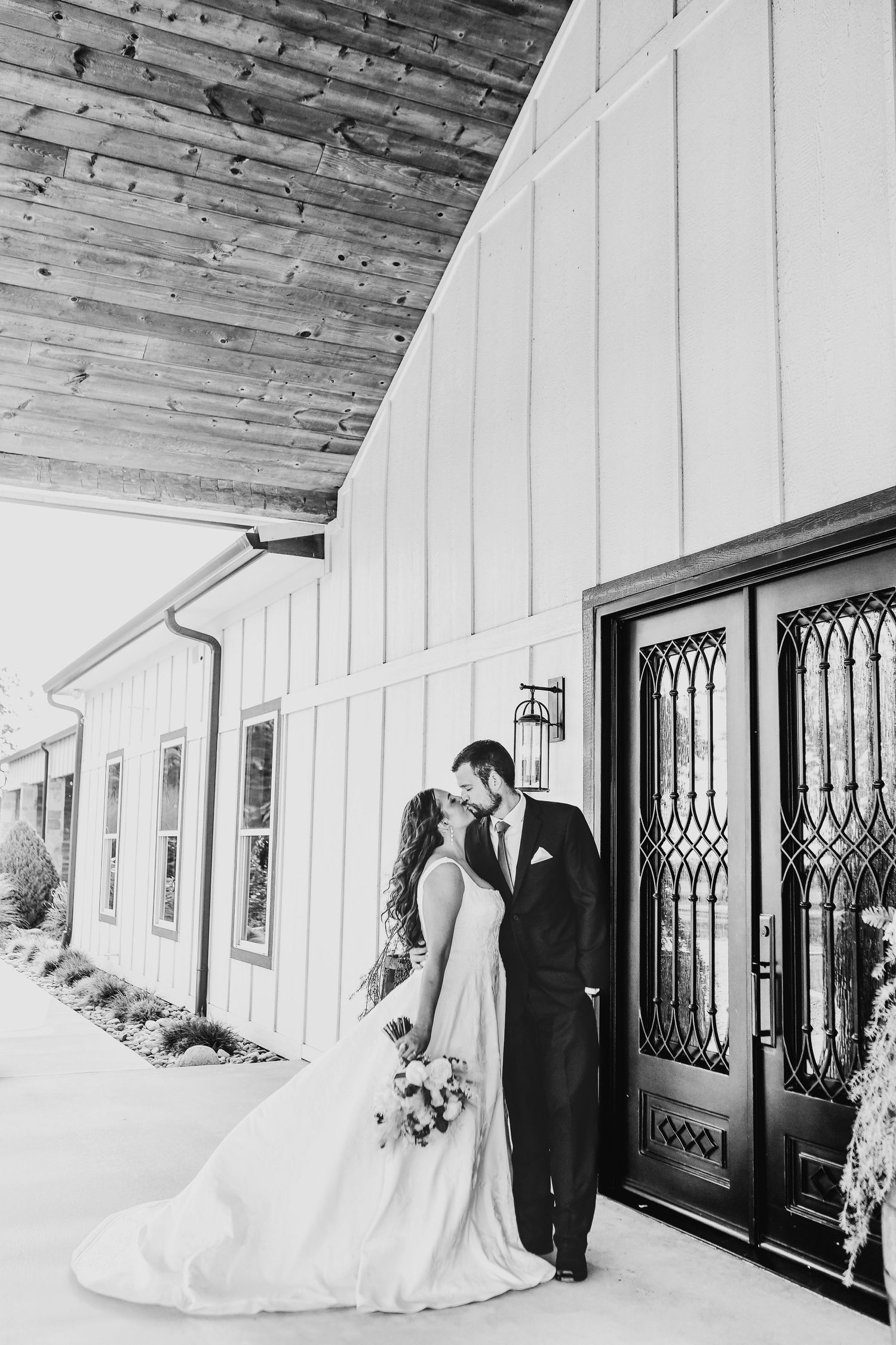 Romantic black and white photo of bride and groom at The Madelyn barn