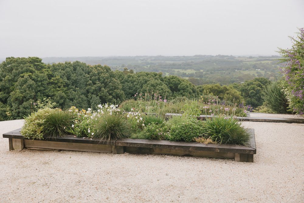 Scenic garden planters overlooking a rolling countryside landscape.