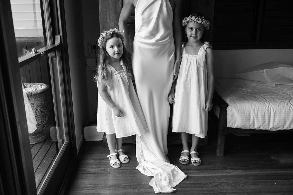 Black and white wedding photograph showing white dresses and shoes.