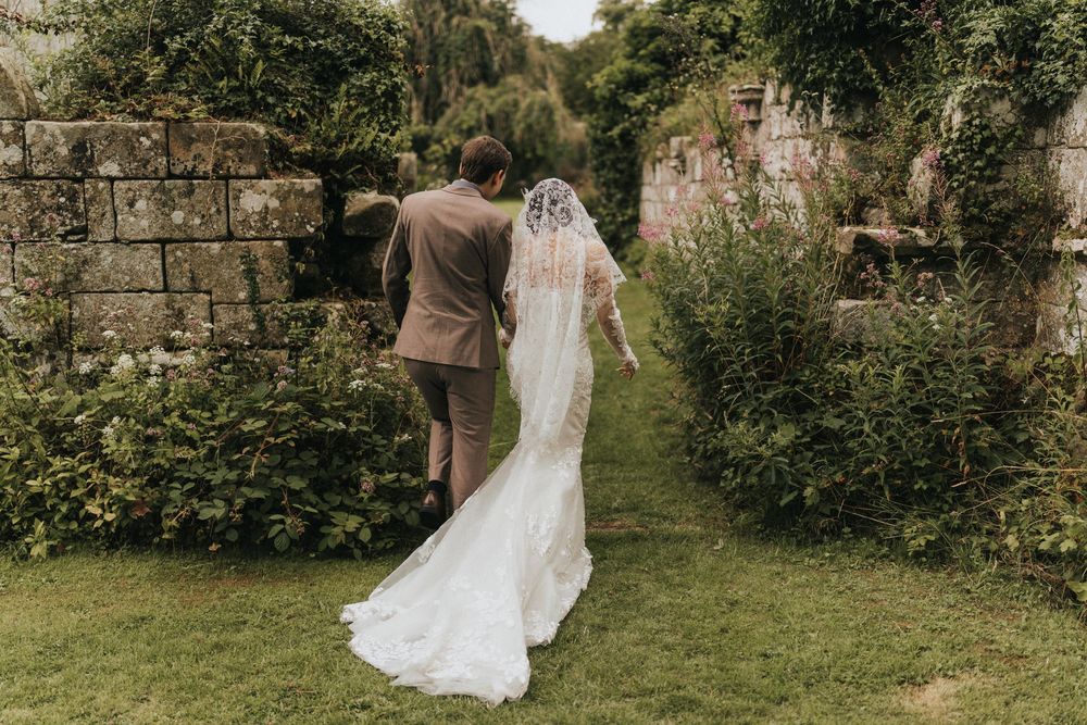 A wedding scene in a lush garden setting with flowing white dress and soft natural light creating a romantic atmosphere.