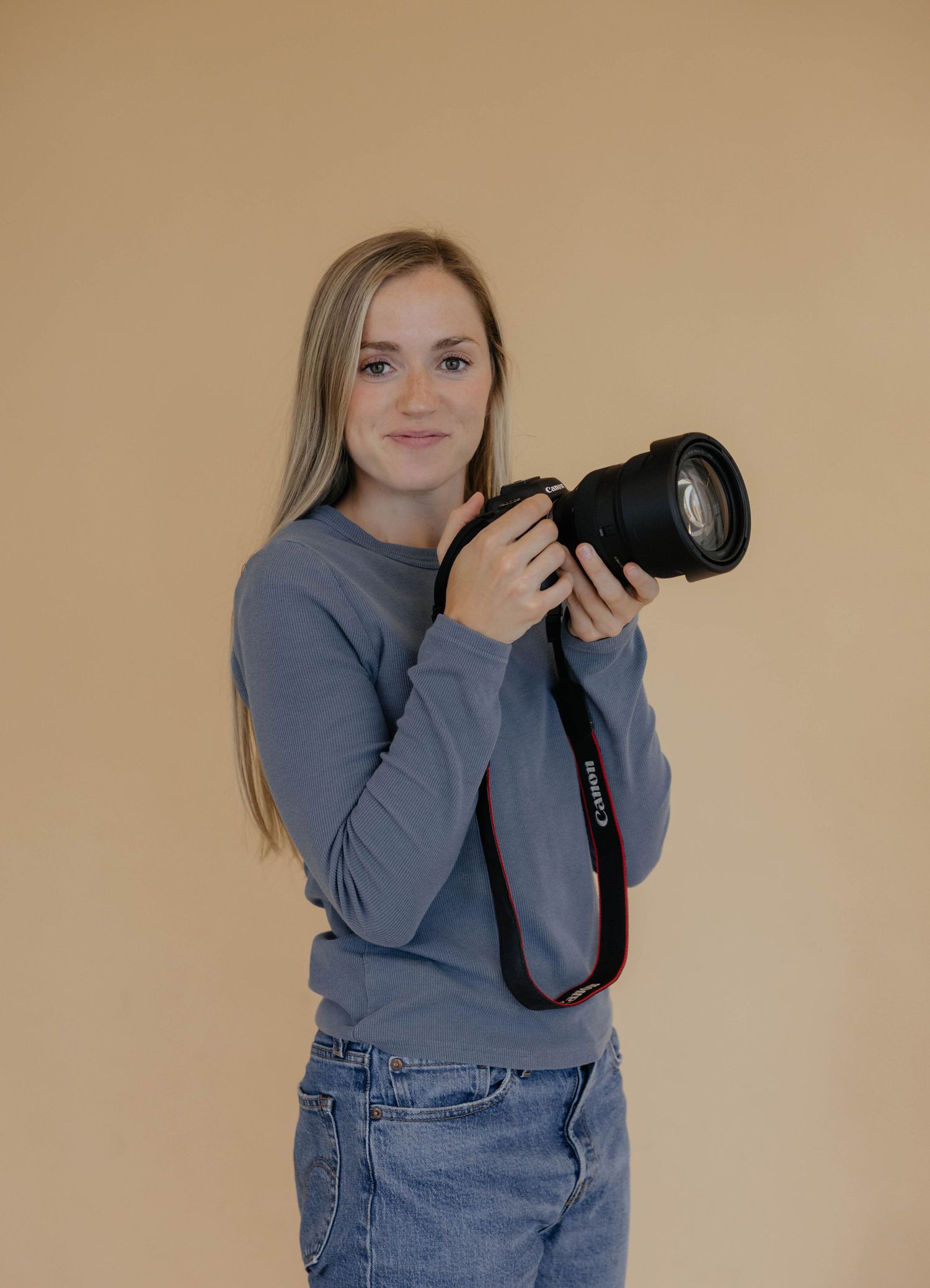 A series of photos showing a photographer in a blue sweater and jeans practicing different camera holding positions.