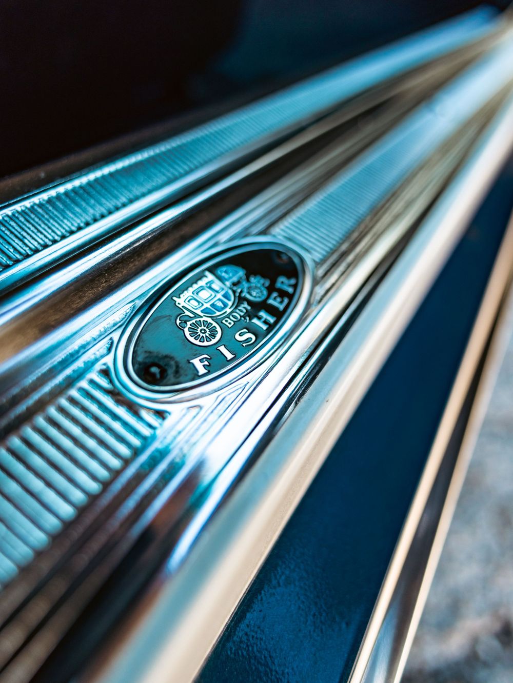 Detailed shot of chrome trim and Stinger badge on classic car side panel.