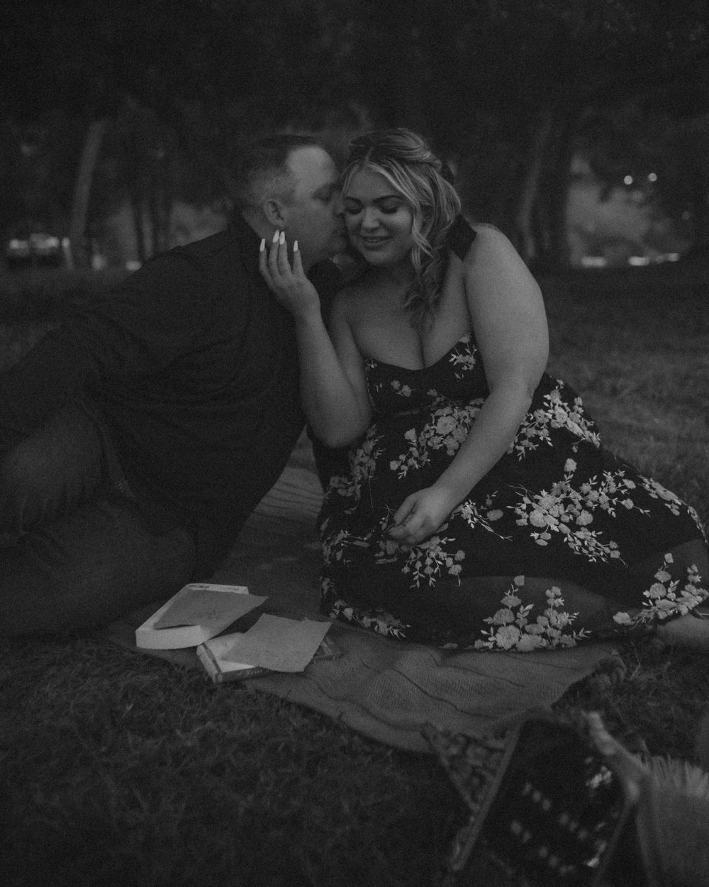 Black and White cinematic photo of a couple enjoying their picnic