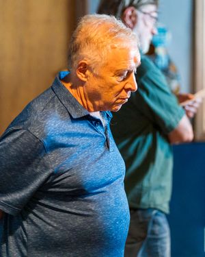 Someone in a blue shirt seen in a series of progressive profile shots turning their head.