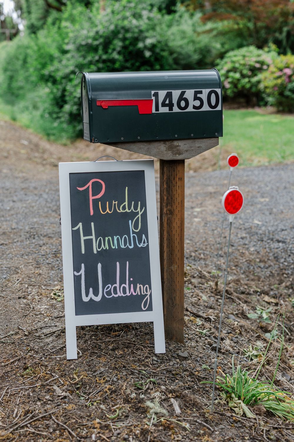 A mailbox numbered 14650 with a chalkboard sign announcing Purdy Hannah's Wedding beneath it.