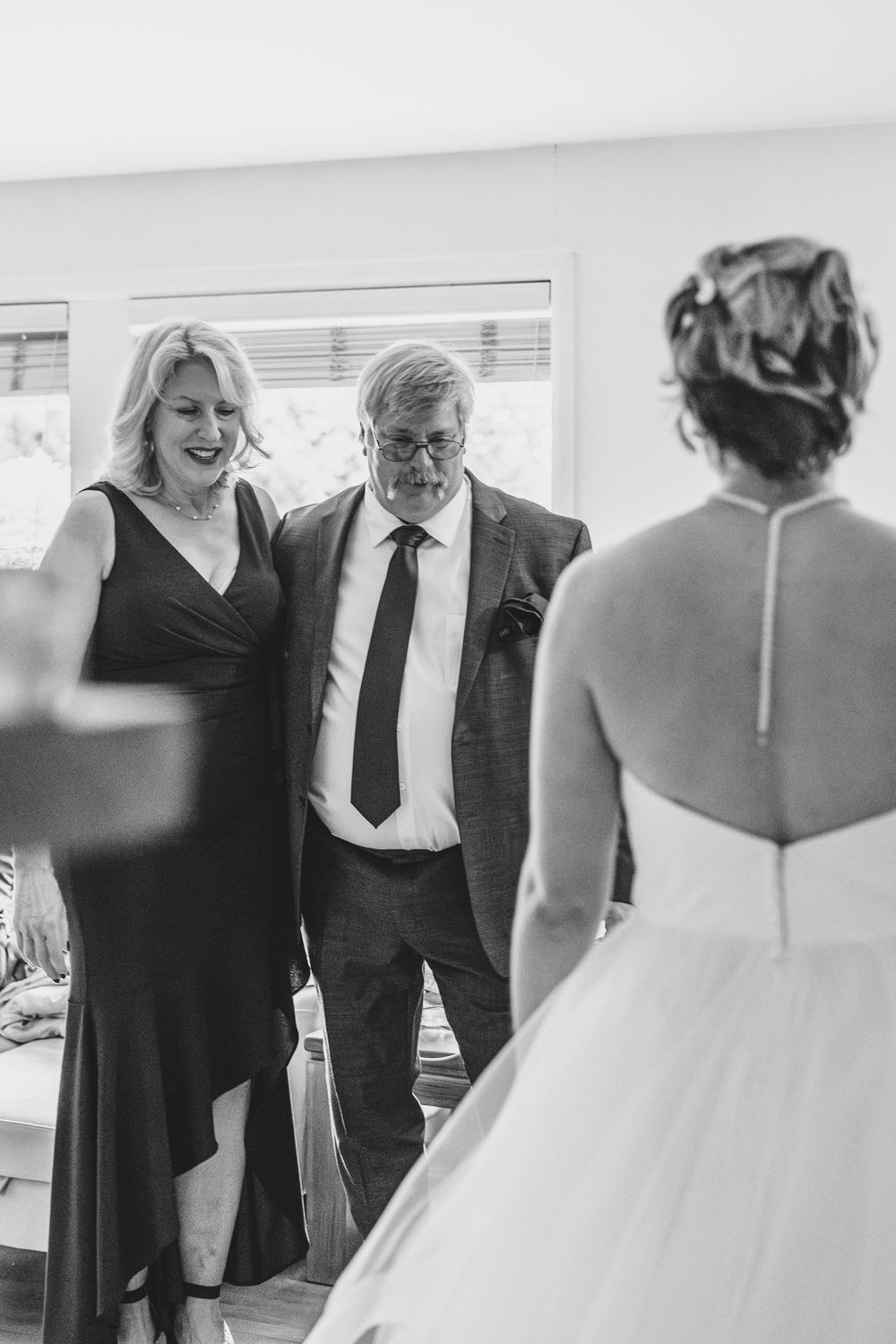 Black and white photo of emotional first look reactions during special moment at a wedding ceremony.