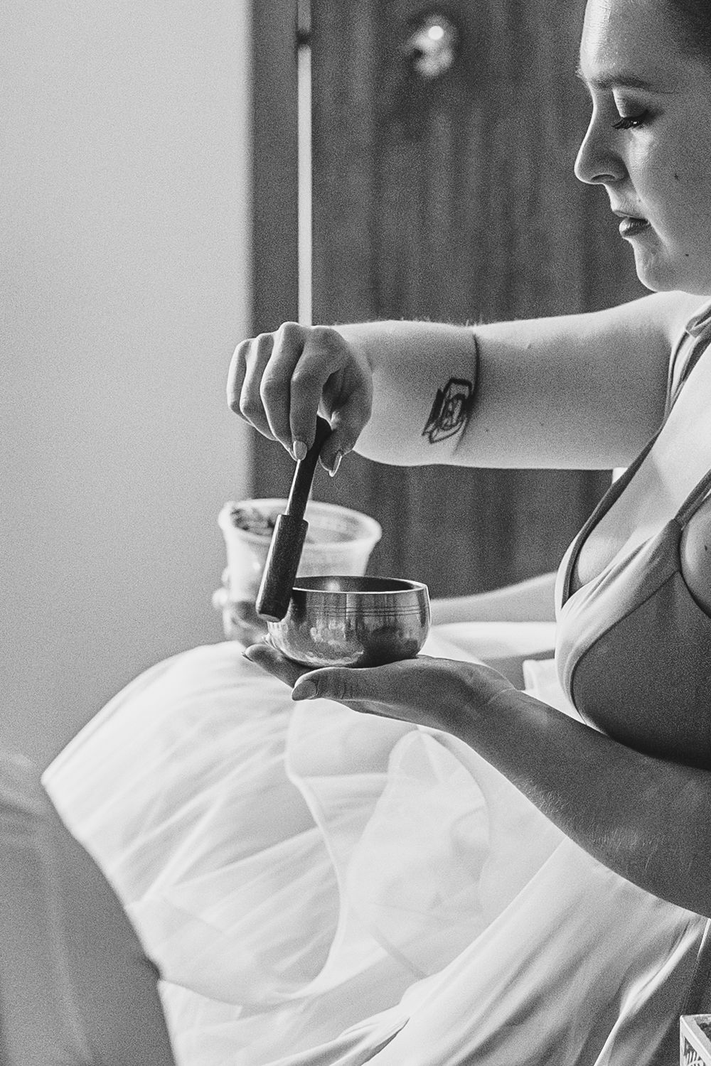 A woman in white robe relaxes while receiving a luxurious spa treatment in a tranquil setting.