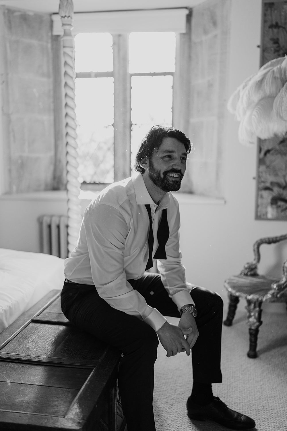 A collected series of black and white photographs showing someone sitting and posing on a carpeted floor.