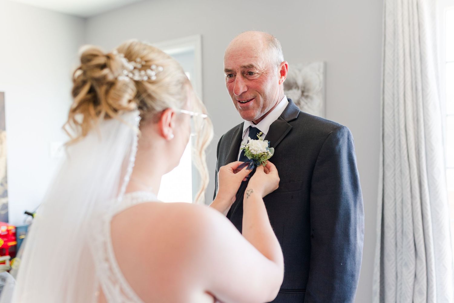 A touching wedding scene shows a special moment between a person in a bridal gown and someone wearing a formal suit.