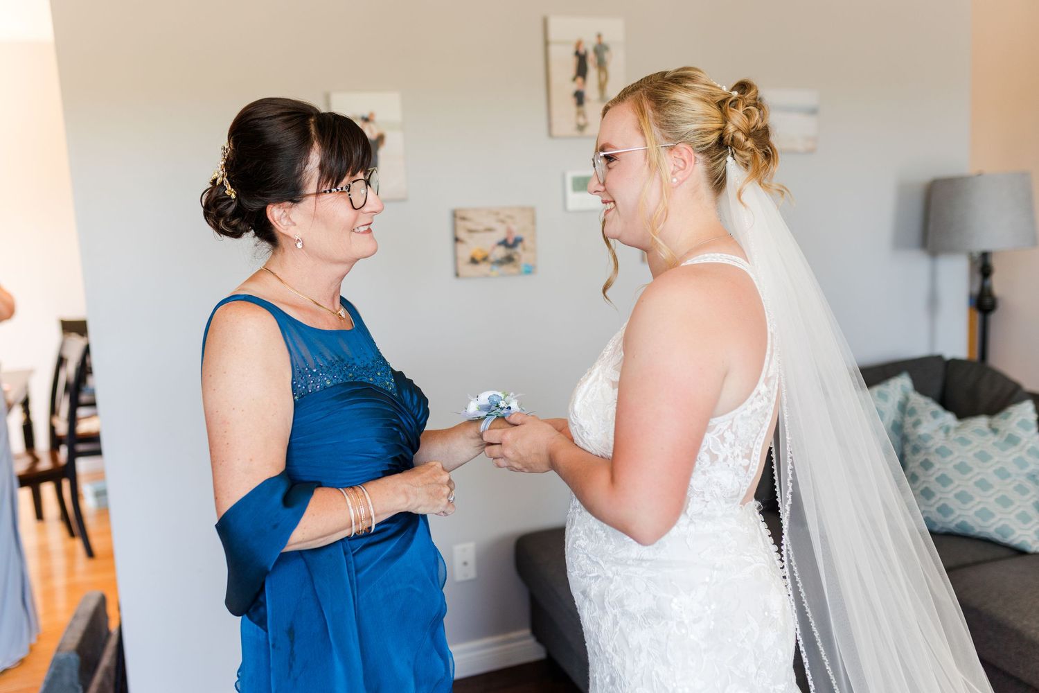 People in wedding attire share emotional embraces and joyful moments during a pre-ceremony gathering.