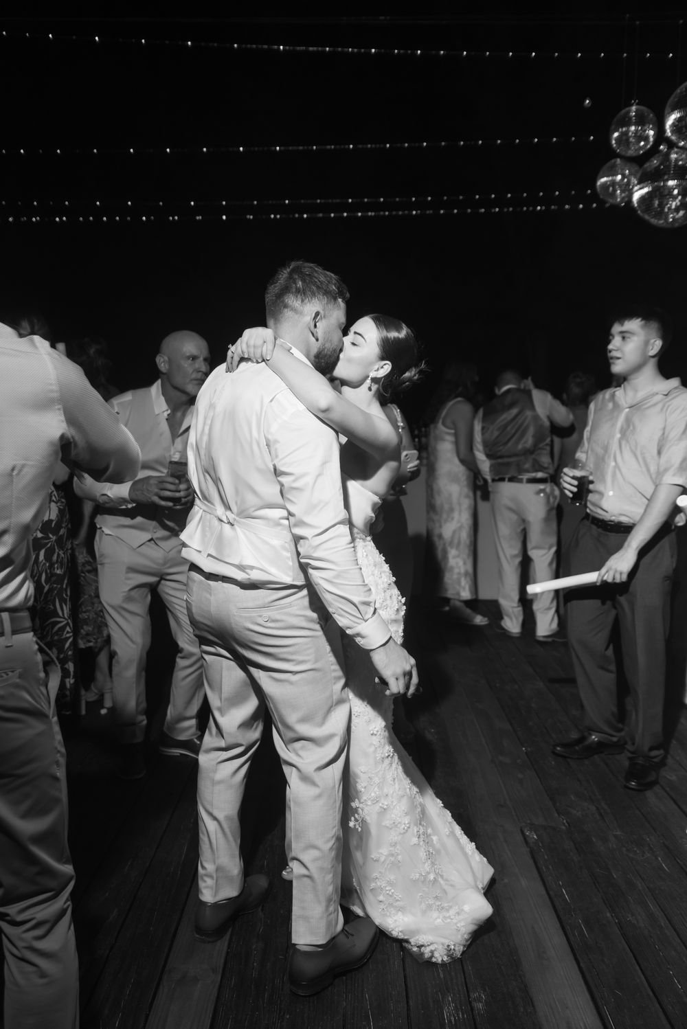 Dancers move energetically on a wooden dance floor in a vintage black and white photo sequence.