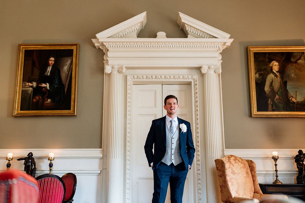 An elegant traditional wedding photo sequence taken at a historic manor with framed portraits and architectural details.