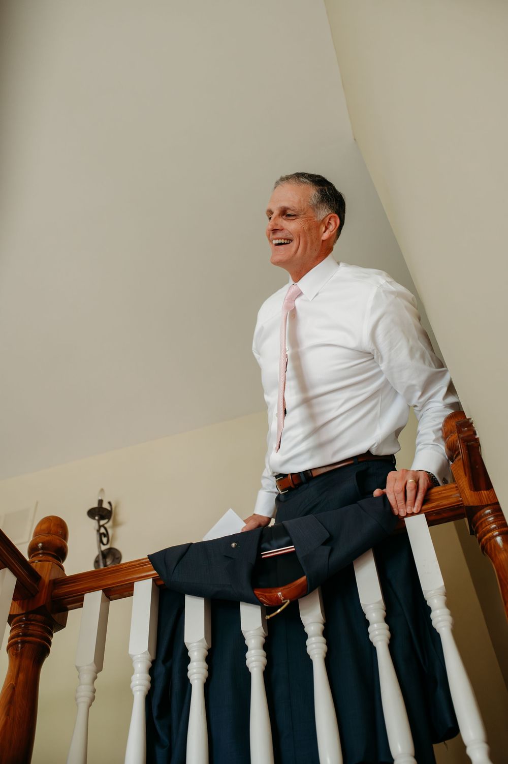 A sequence of photos showing a person in white shirt and dark pants sitting on a wooden stair railing.