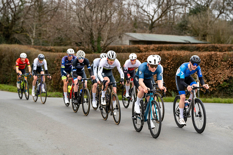 Road cyclists in long line during a race in Devon