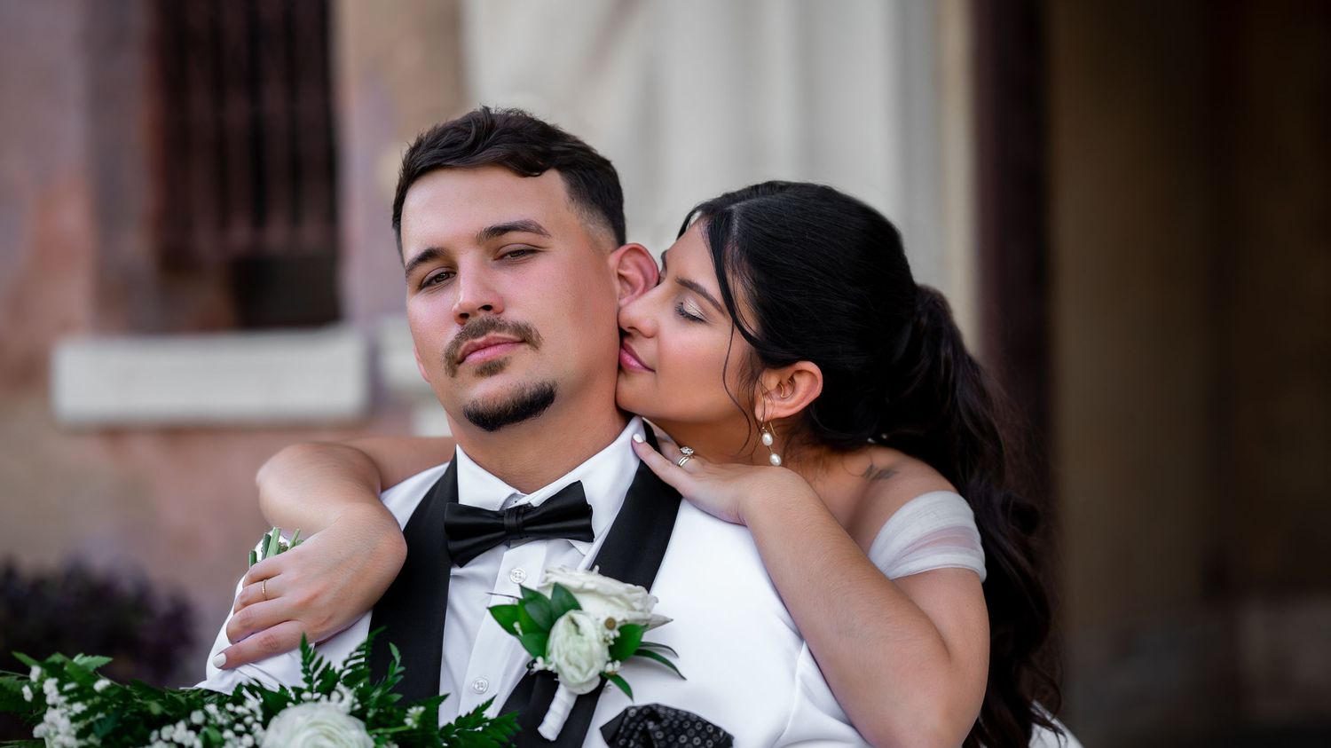 Romantic golden hour portrait in front of ivy-covered arches at Howey Mansion, taken by a Florida destination wedding photographer.