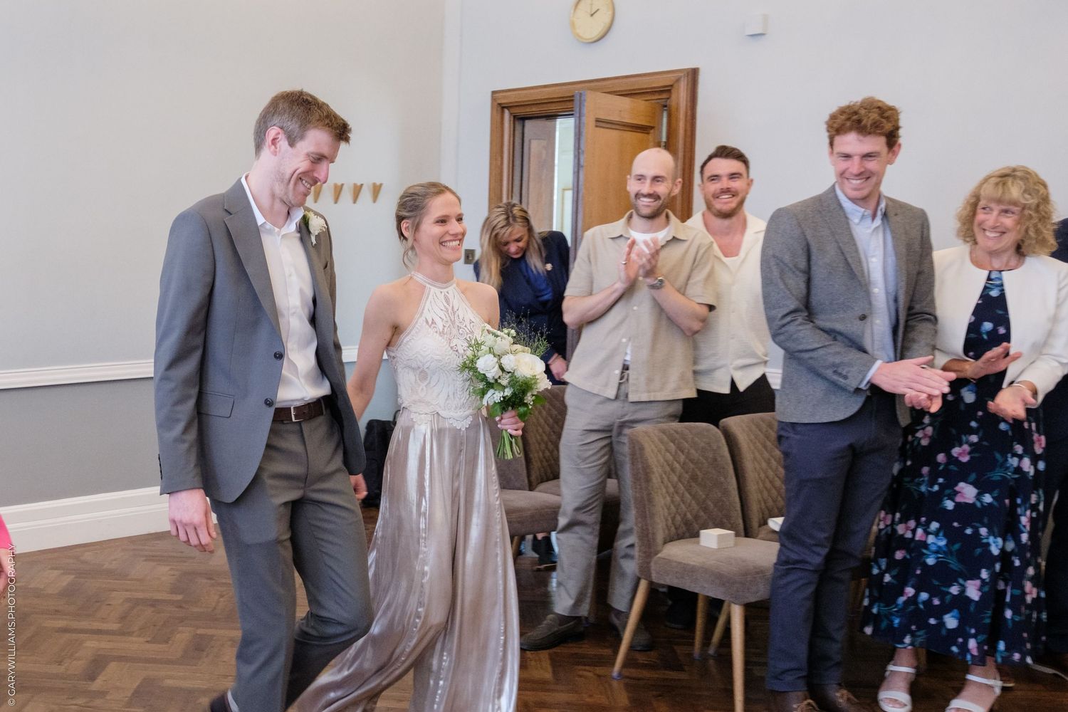 Wedding party members share laughter and joy during a casual moment at the reception.