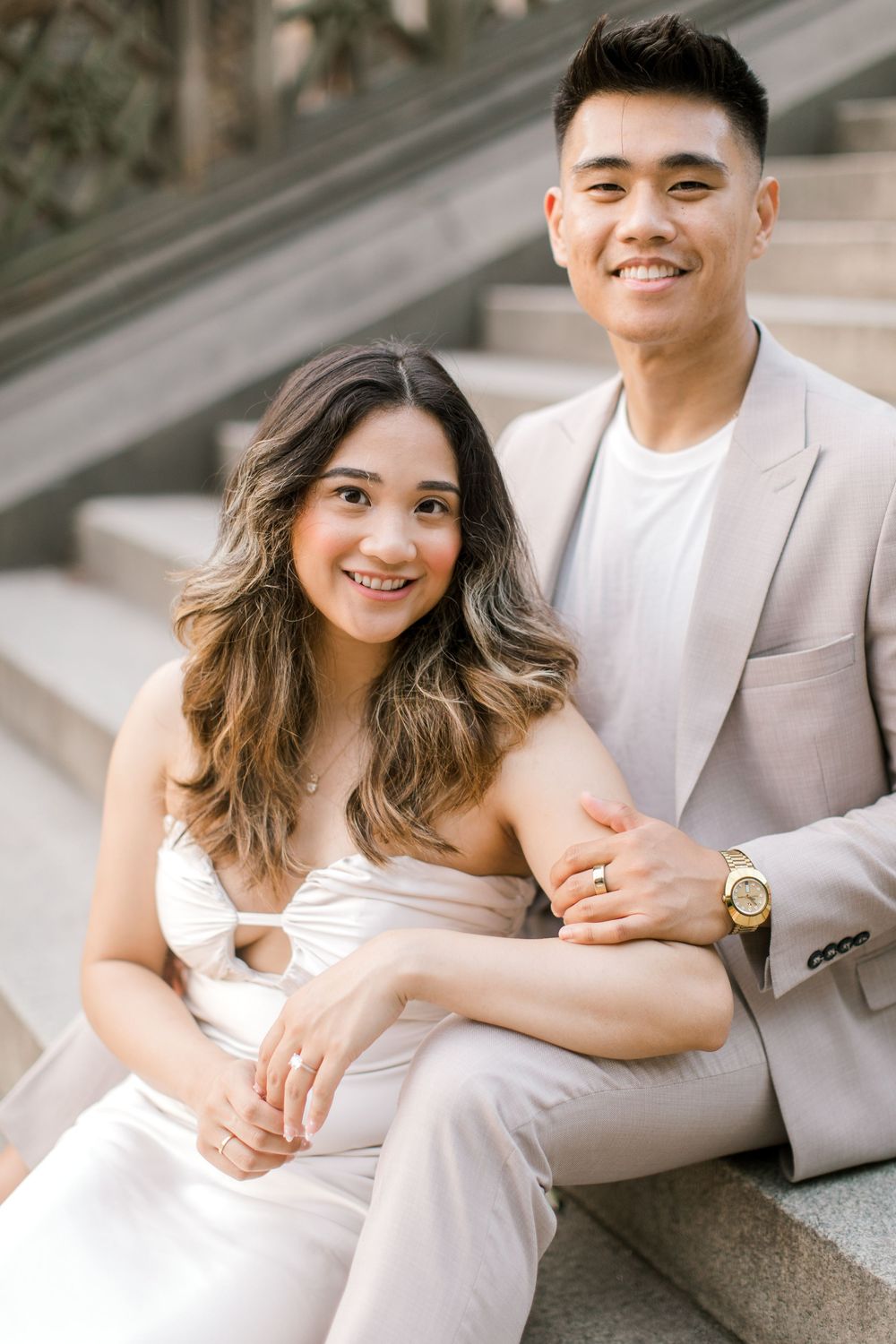 Engaged couple sharing a romantic moment by the iconic Bethesda Fountain in NYC.