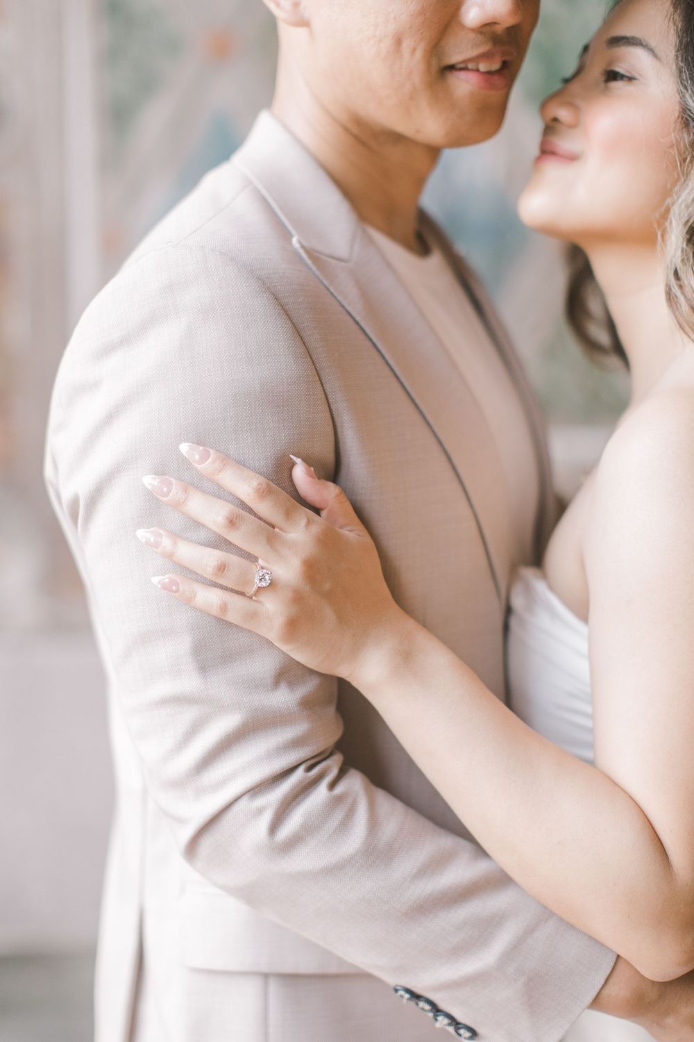 Engaged couple sharing a romantic moment by the iconic Bethesda Fountain in NYC.