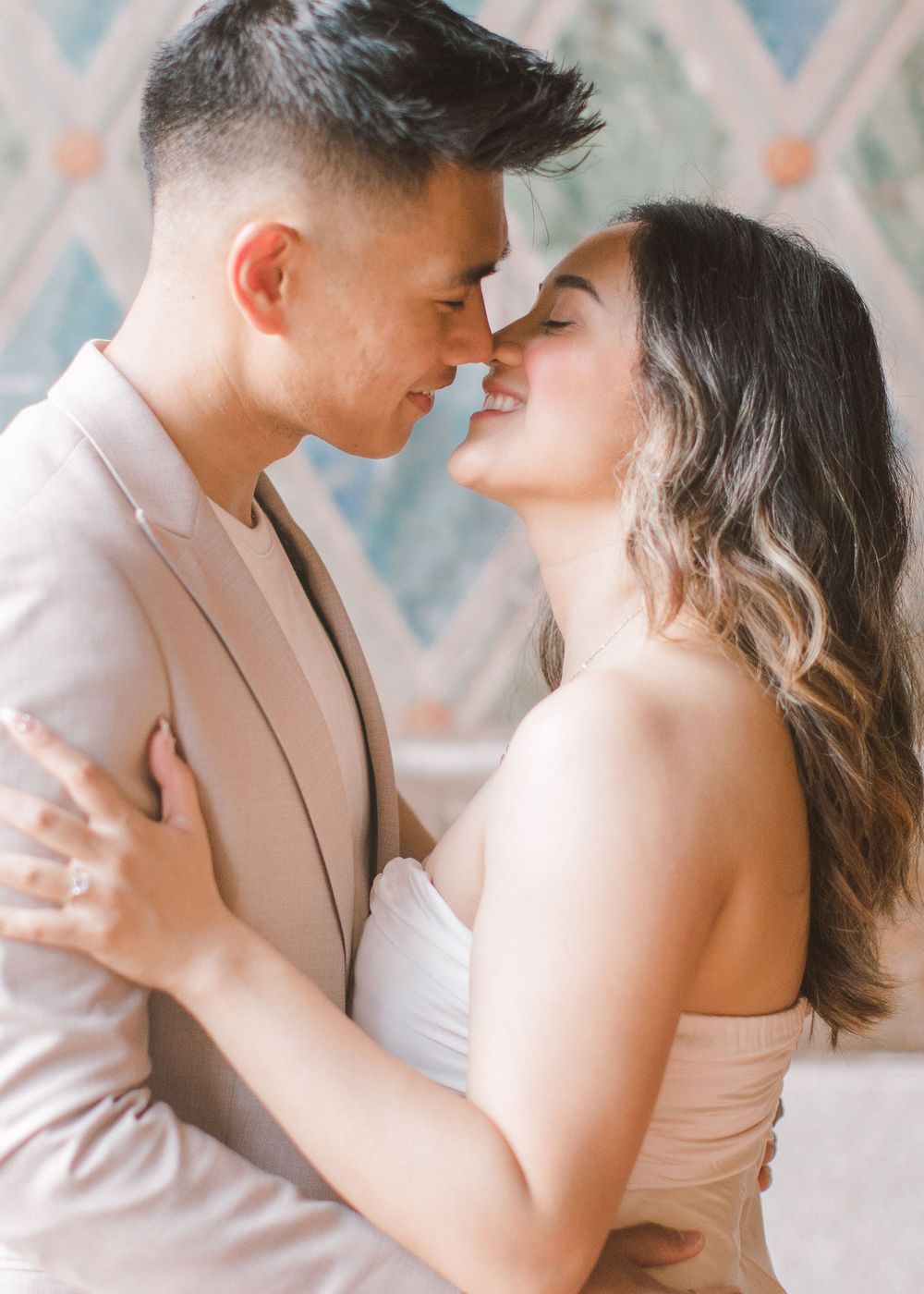 Engaged couple sharing a romantic moment by the iconic Bethesda Fountain in NYC.