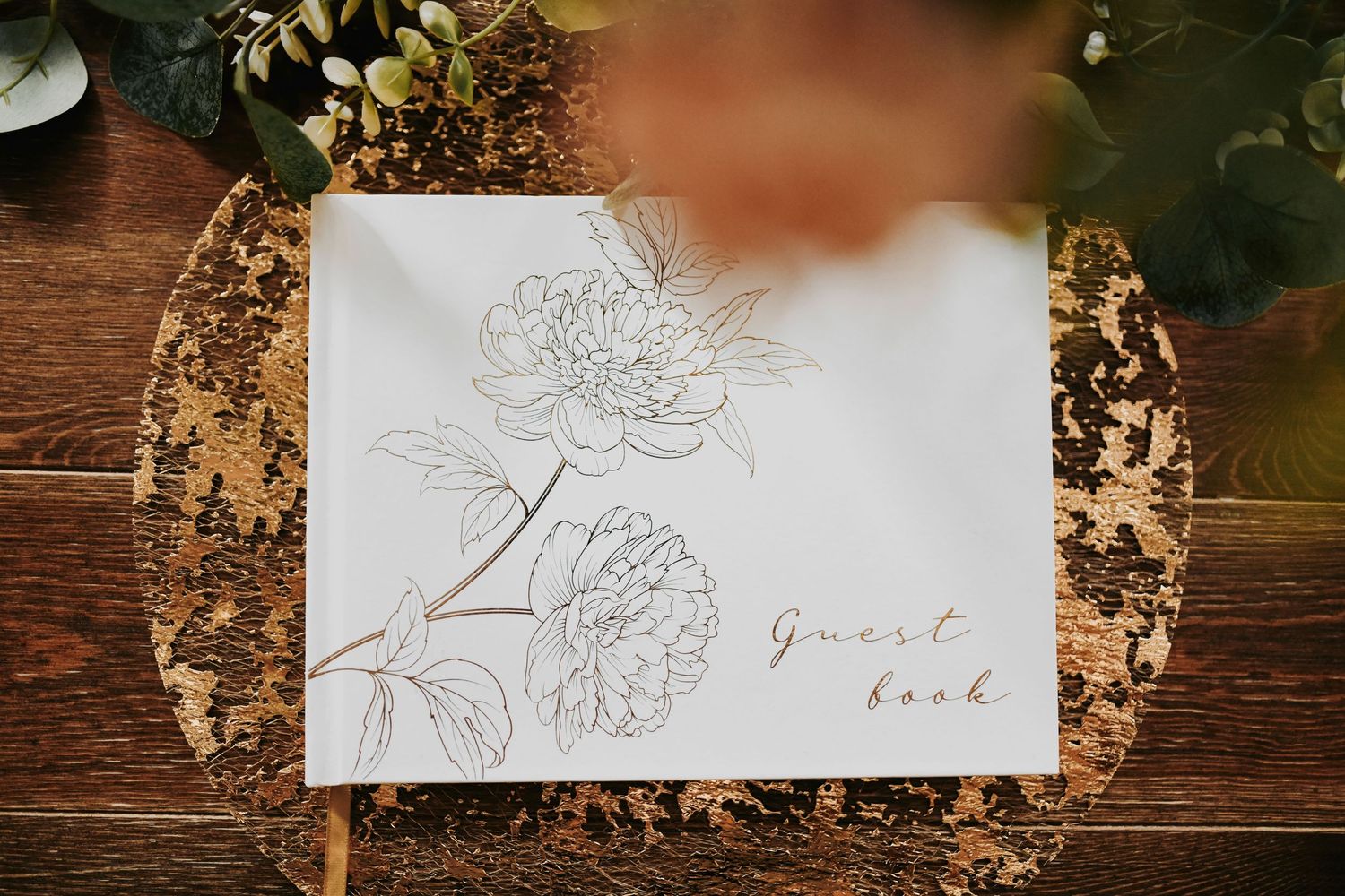 Detail shot of guest book and cascading blooms