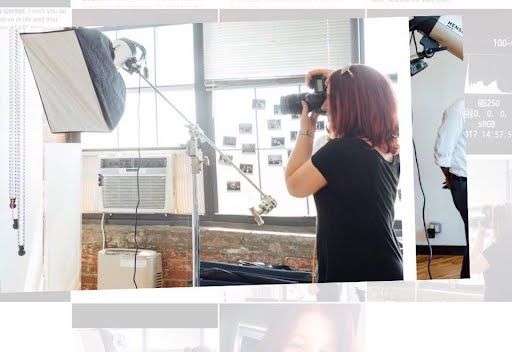Professional photographer captures content in a studio space with a softbox light and brick wall backdrop.